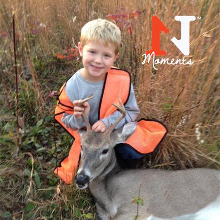 boy posing with first deer
