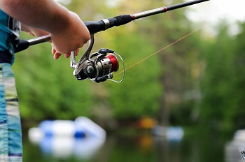 person holding a spinning reel