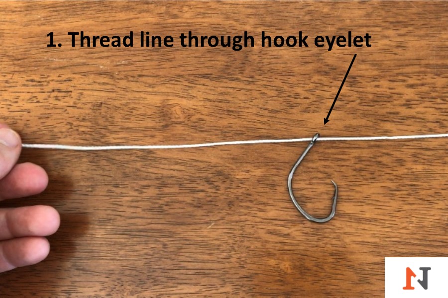 threading line through hook eyelet for palomar knot