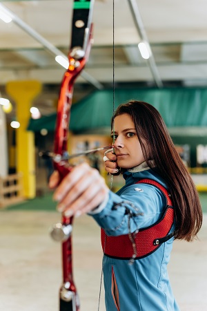 girl shooting an archery bow