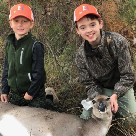 two boys with doe deer