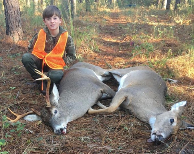 boy with buck and doe