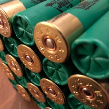green apex ammunition shotgun shells in a stack