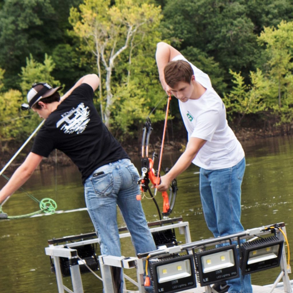 two guys bowfishing