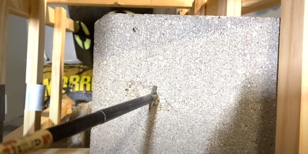 iron will single bevel embedded in cinder block