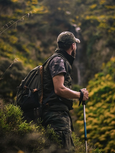 man holding hiking poles