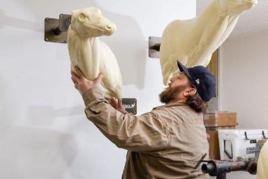 man working on taxidermy mount