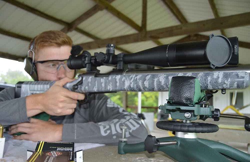 man sighting in a riflescope