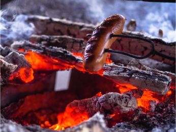 hot dog roasting on campfire
