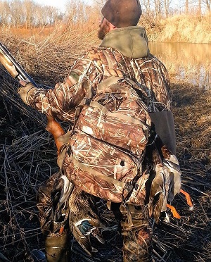 man holding duck hunting shotgun