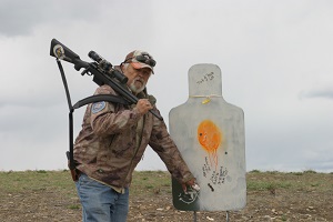 man on rifle range holding rifle