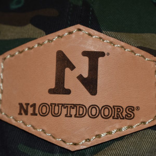 closeup of n1 outdoors leather patch on green camo hat