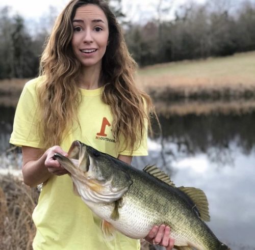 Aly from Alabama holding monster largemouth bass and wearing N1 Outdoors fishing shirt