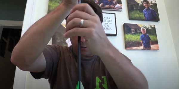 inserting homemade lighted nock into arrow shaft
