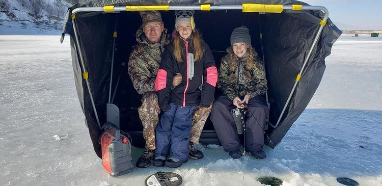 ice fishing family in tent