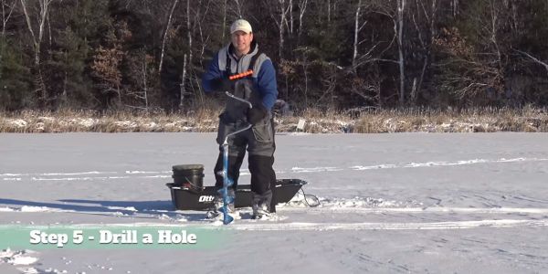 man holding ice fishing auger