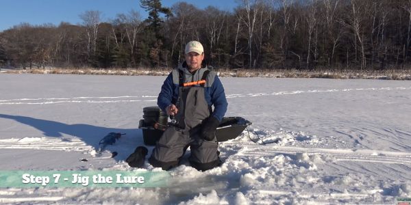 man jigging ice fishing lure