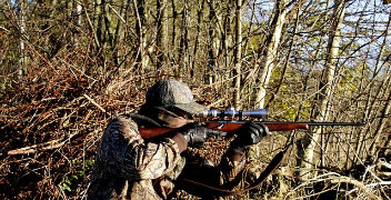 hunter shooting rifle