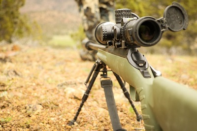 hunting rifle on tripod