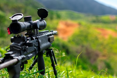 rifle pointing down hillside