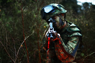 man holding gun with laser range finding scope