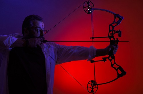 man holding compound bow