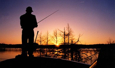 man fishing at dusk dawn