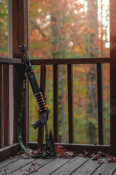home defense shotgun on house porch