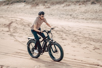 man riding e-bike in sand