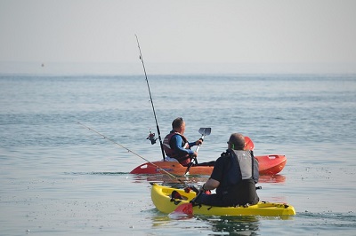 two men fishing from kayak