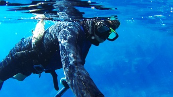 man with fish spearfishing