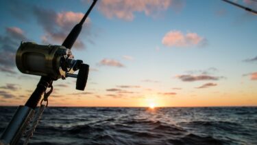 fishing reel on boat at sunrise