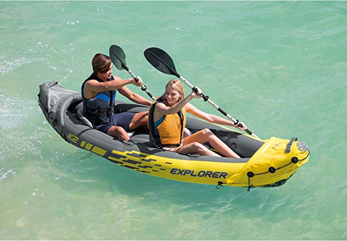 man and woman riding in inflatable kayak