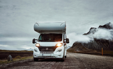 rv with mountain and clouds in background