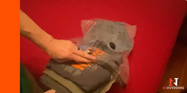 putting shirts in flextail vacuum bag