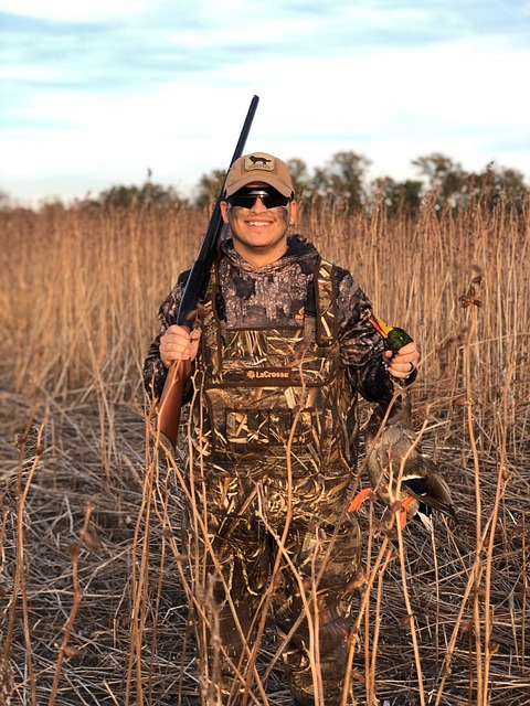 duck hunter holding a mallard
