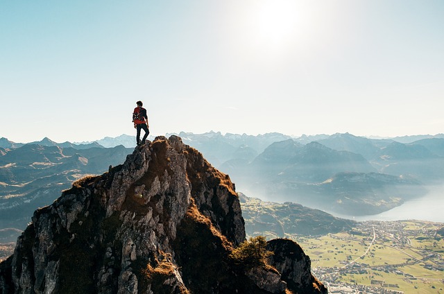 hiker standing on a peak