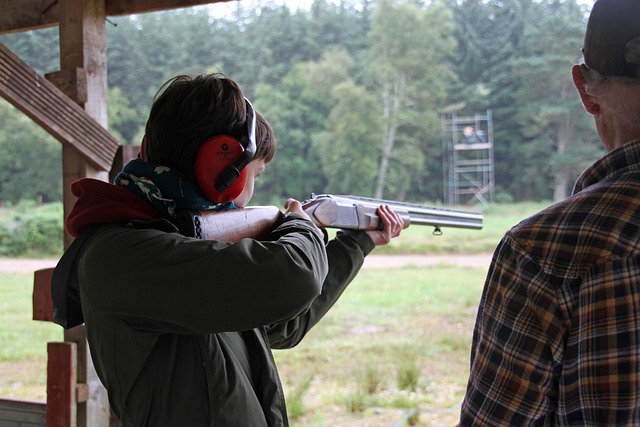 youth shooting shotgun at range