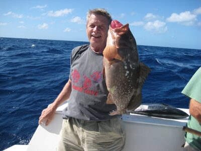 man holding a grouper