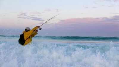 man fishing in the surf