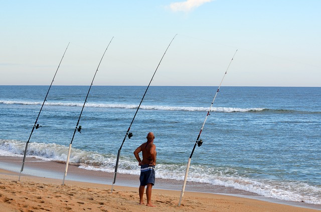 man surf fishing with multiple rods