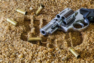 handgun and ammo in the dirt