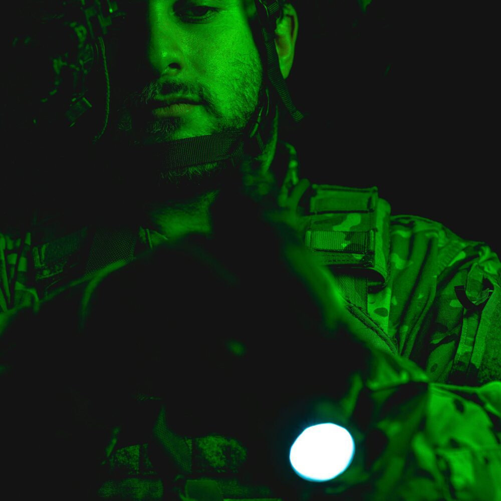 man with green night vision equipment