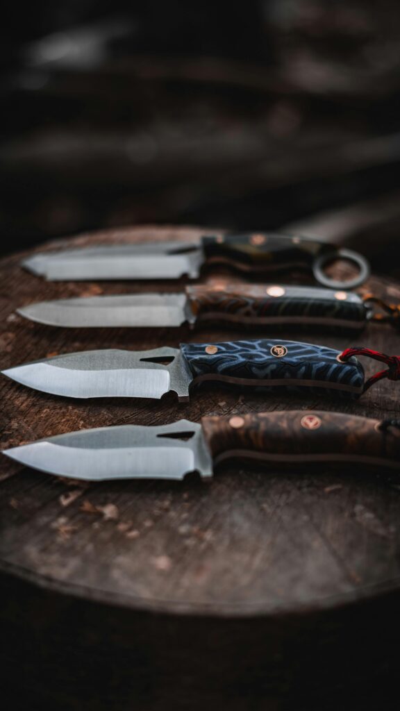 4 hunting knives on stump