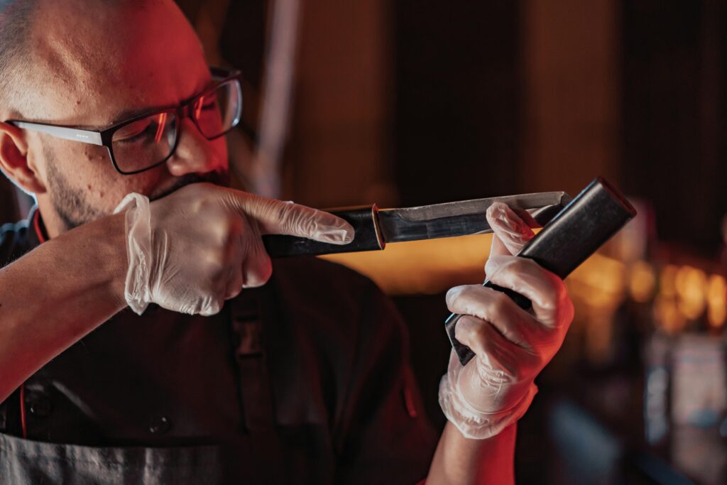 man looking down blade of knife