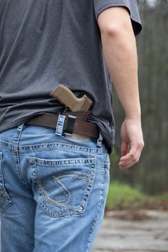 man standing with gun in holster