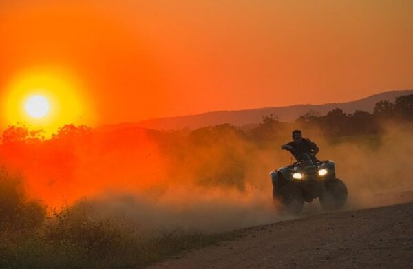 riding atv at sunset