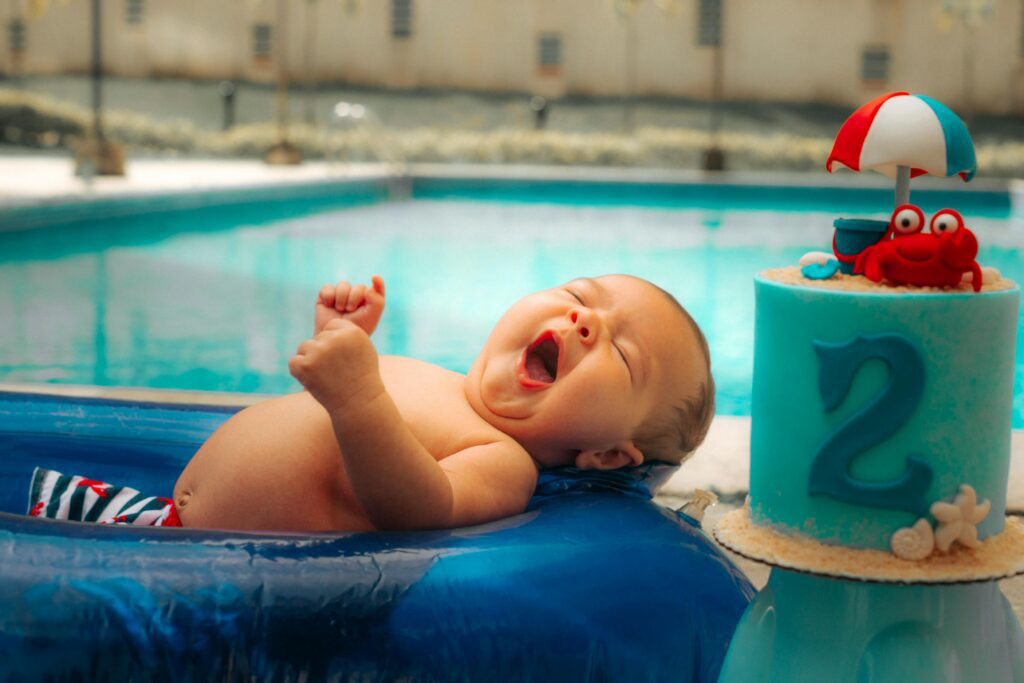 baby in float beside pool