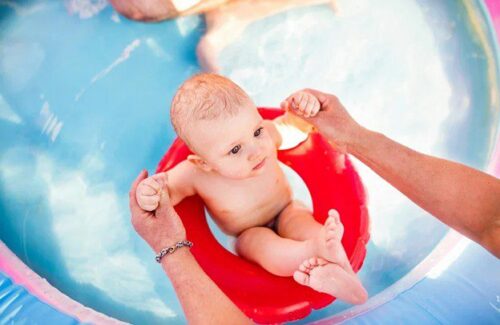 baby in red pool float