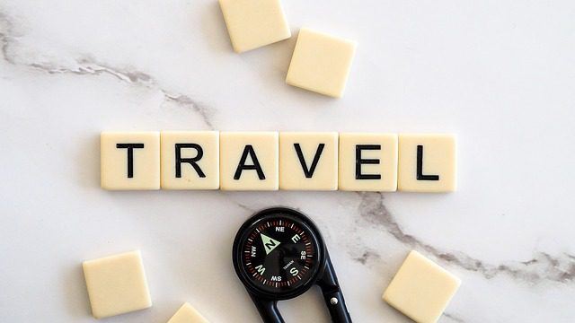 the word travel made with tile letters